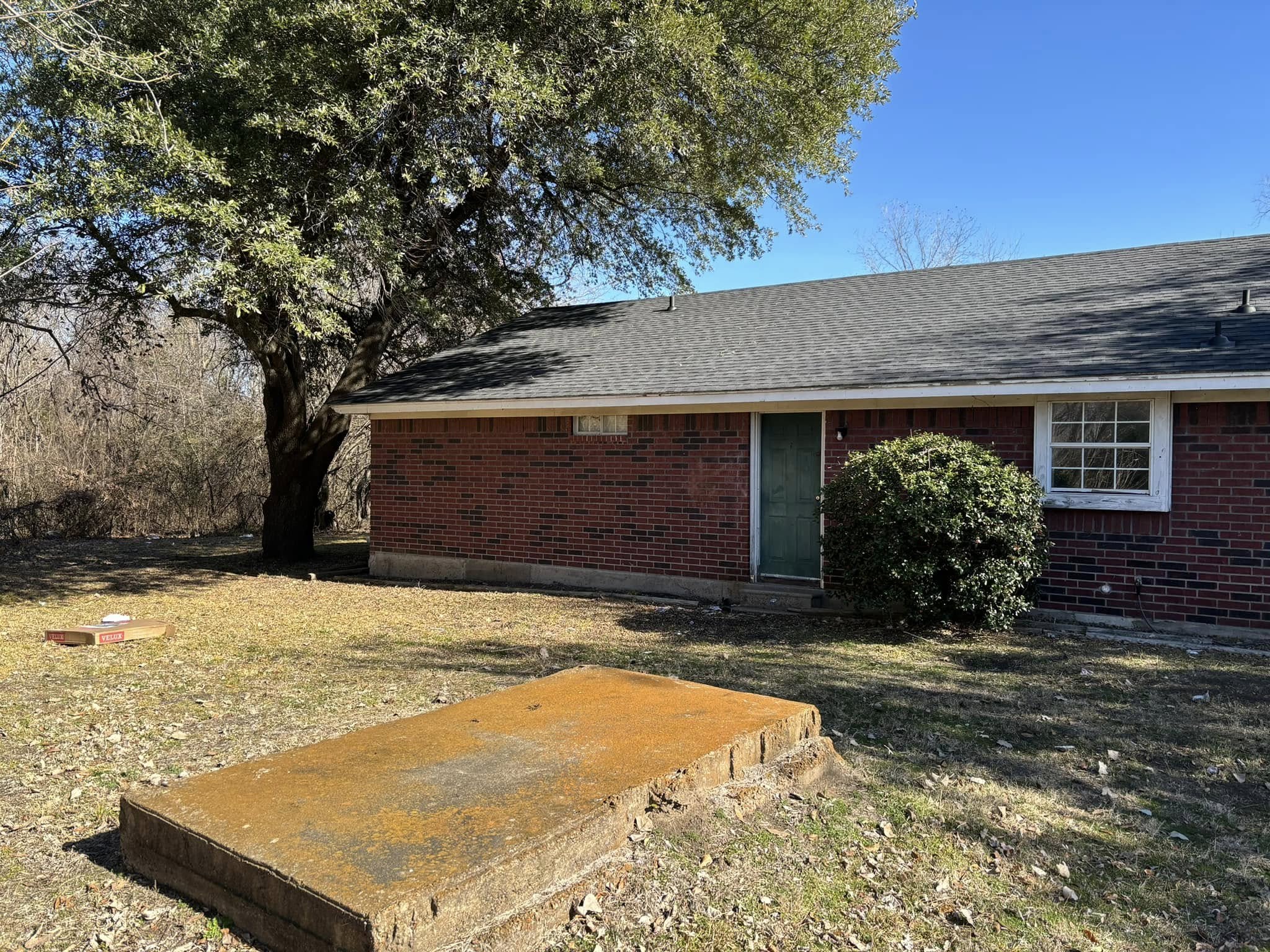Finished brick home with a new premium shingle roof by VIP Roofing Co. in Paris, TX